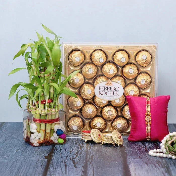 Ferrero Rocher chocolate box with a decorative plant and pink pillow on a wooden surface.