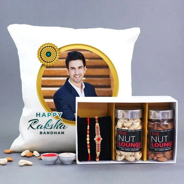 Gift set with a pillow, rakhi, and nut packages on a gray background