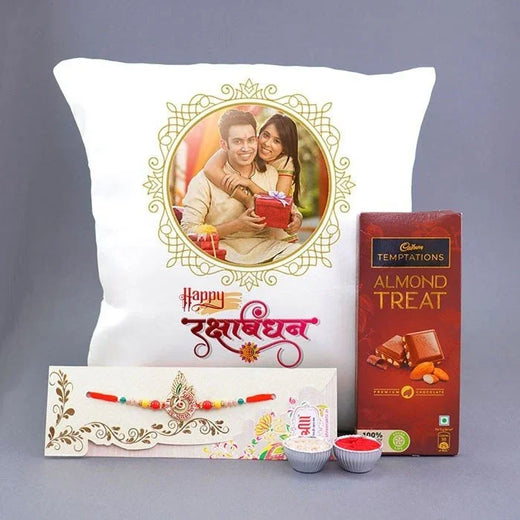 Decorative pillow with a couple photo, chocolate box, and Rakhi on a gray background