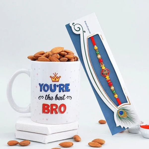 Mug with 'You're the best BRO' text and almonds, next to a Rakhi on a white background