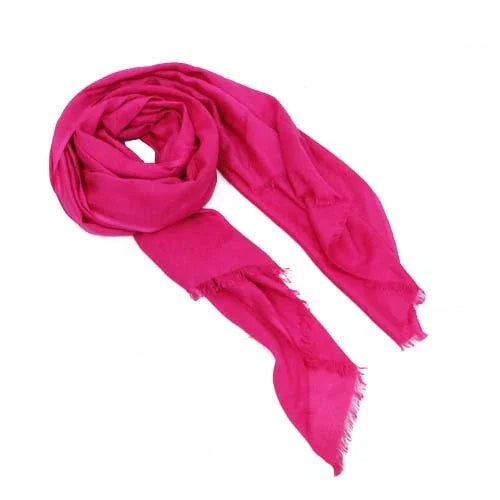 Bright pink women’s scarf with frayed edges on a white background