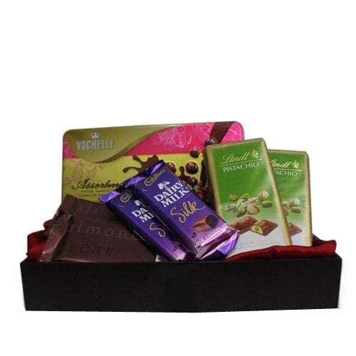 Assorted chocolate bars and packaging in a box on a white background
