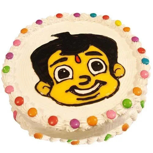 Round cartoon character cake with white icing and colorful candy decorations, birthday gift