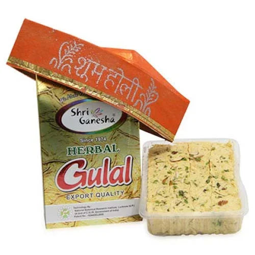 Shri Ganesh Herbal Gulal packaging with a Soan Papdi container of gulal on a white background