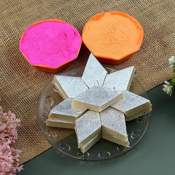 Decorative plates with pink and orange colors on a textured surface with a plate of sliced white dessert.