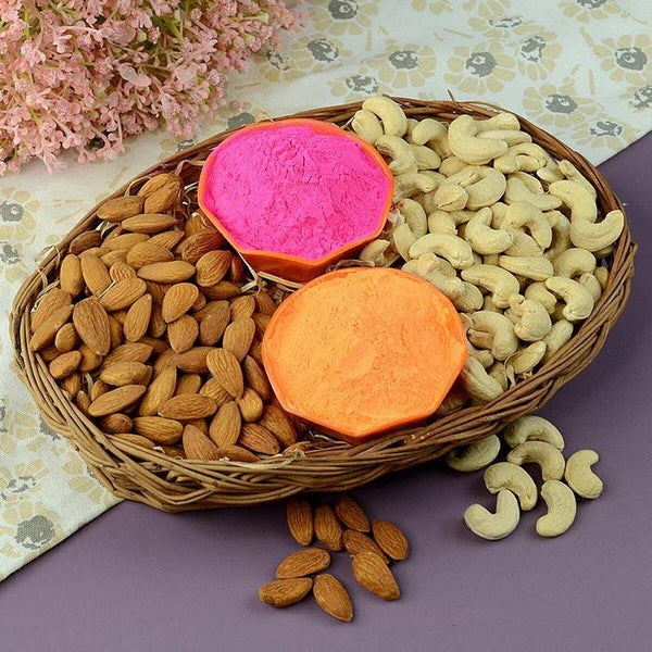 Basket of almonds and cashews with two colorful items on a floral-patterned surface