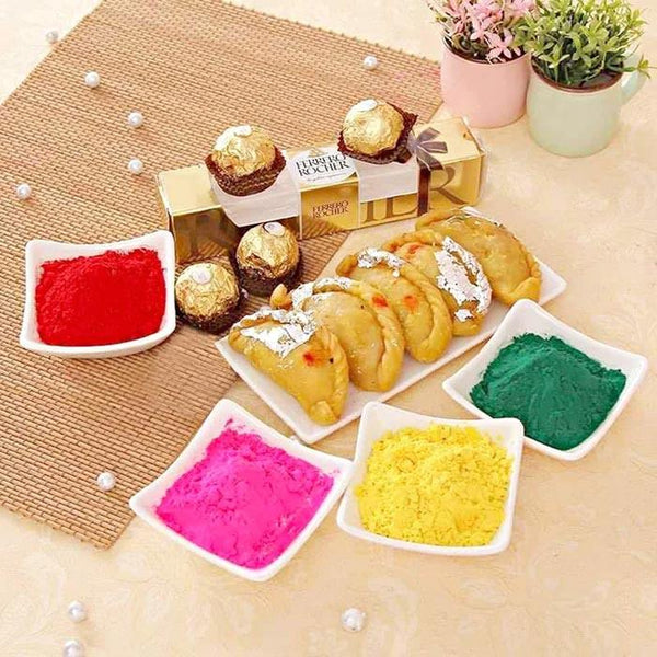 Assorted candies, pastries, and colorful powders on a table with decorative elements.