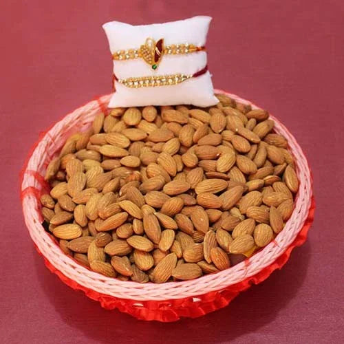 Basket of almonds with a small pillow and jewelry on a red background
