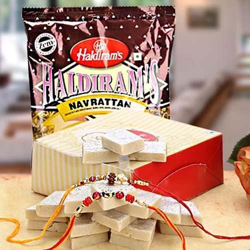 Box of Indian sweets, Haldiram's Navrattan snacks, and festive rakhis on a table