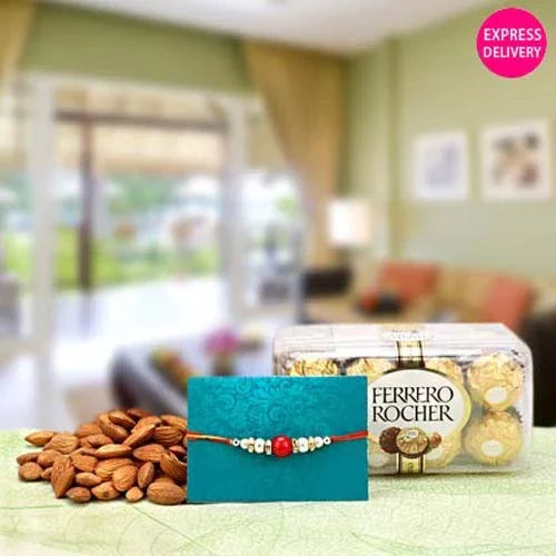 Ferrero Rocher chocolate box, teal rakhi, and almonds on a table with a blurred room background