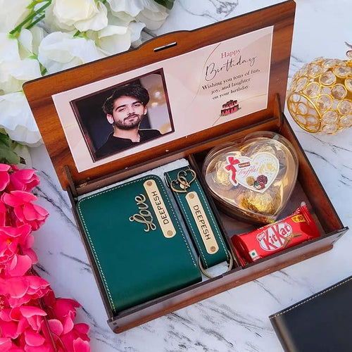 Gift set with a wallet, heart-shaped chocolate, and KitKat bar in a wooden box with a photo of a man on the lid.