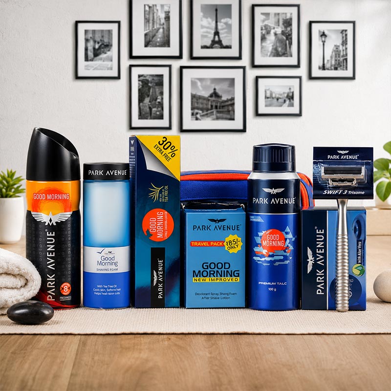 Collection of Park Avenue men's grooming products on a wooden surface with framed pictures in the background.