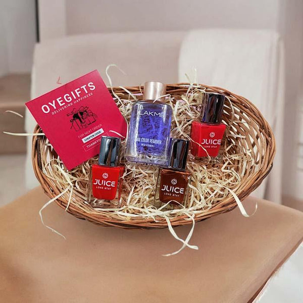 Gift basket with Juice nail polish bottles, Lakme nail polish remover, and a red greeting card