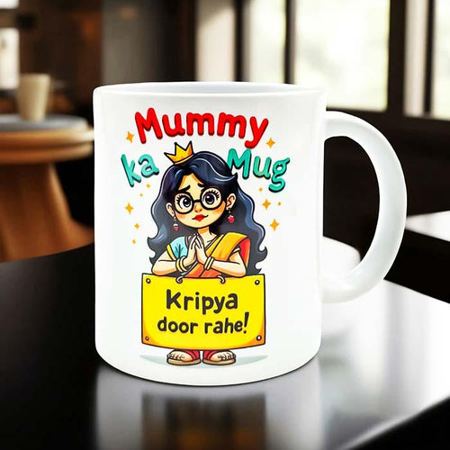 White mug with cartoon character and text on a table