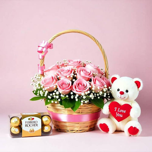 Basket of pink roses, Ferrero Rocher chocolates, and a teddy bear with 'I Love You' heart on a pink background