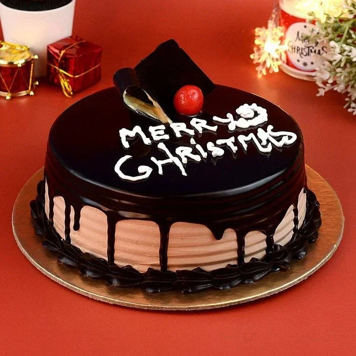 Chocolate cake with 'Merry Christmas' decoration on a red background