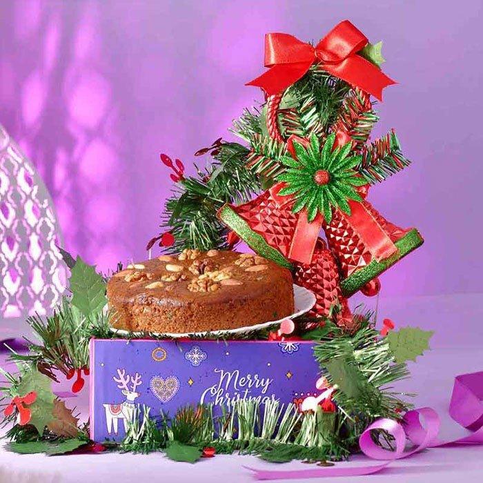 Decorative Christmas tree with a cake on a purple background