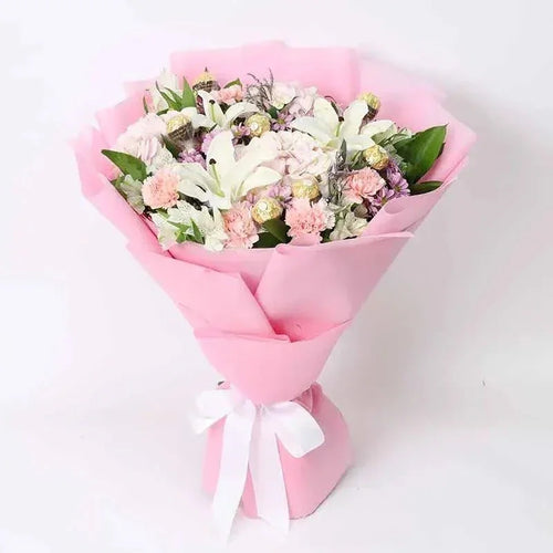 Bouquet of flowers wrapped in pink paper with a white ribbon on a light background