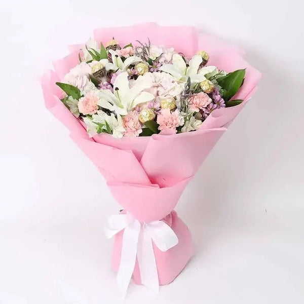 Bouquet of flowers wrapped in pink paper with a white ribbon on a light background
