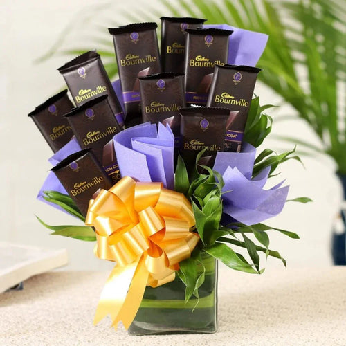 Cadbury Bournville chocolate bars arranged in a flower-like bouquet with a yellow bow.