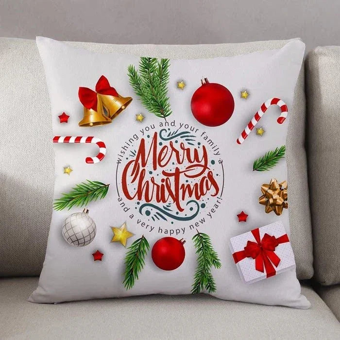 Decorative Christmas pillow with festive elements on a beige couch.