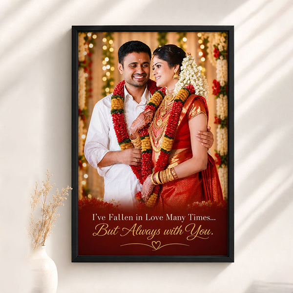 Framed portrait of a couple in traditional attire with decorative text on a white wall.