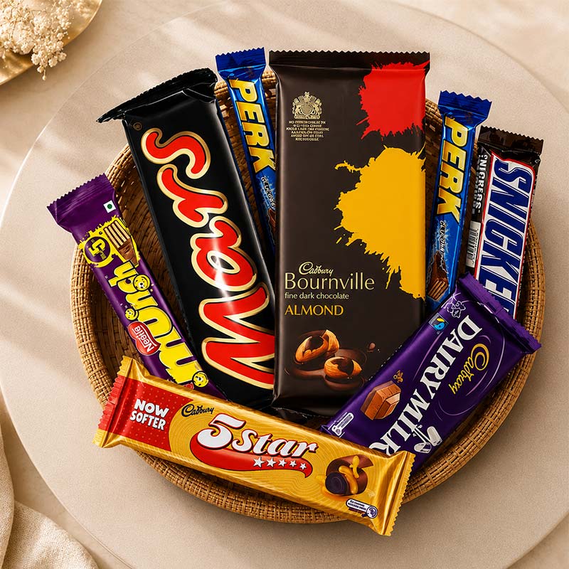 Assorted chocolate bars including Mars, Bournville, and 5 Star on a woven tray.