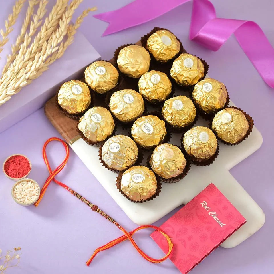 Assorted chocolates in gold wrappers on a white tray with decorative elements on a purple background