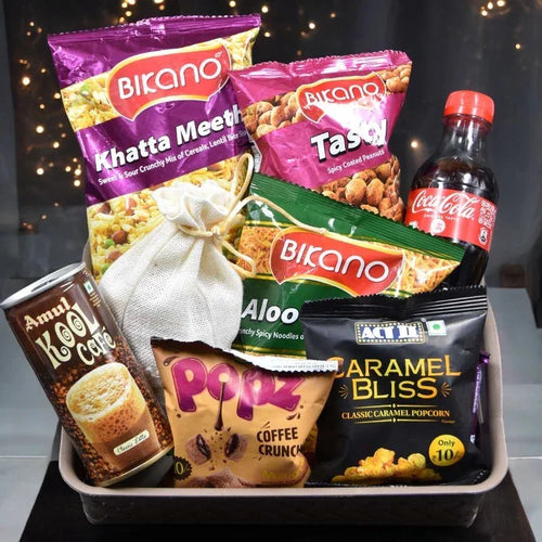 Assorted snack packages including Bikano, Amul, and Coca-Cola on a dark background