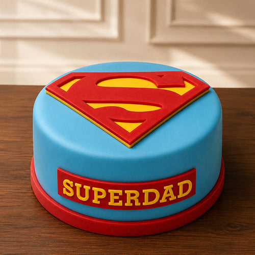 Cake with Superman logo and 'Superdad' text on a wooden surface