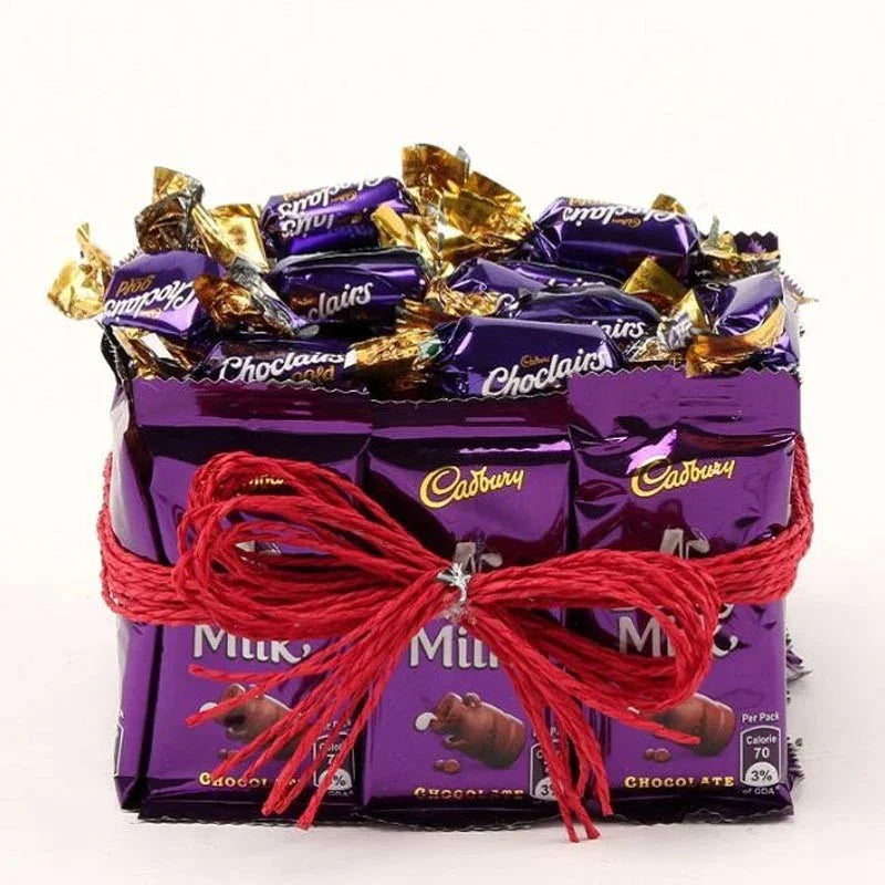 Stack of Cadbury chocolate bars tied with red string on a white background