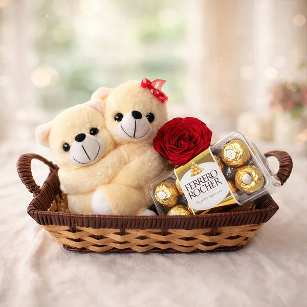 Gift basket with two hugging teddy bears, a red rose, and Ferrero Rocher chocolates