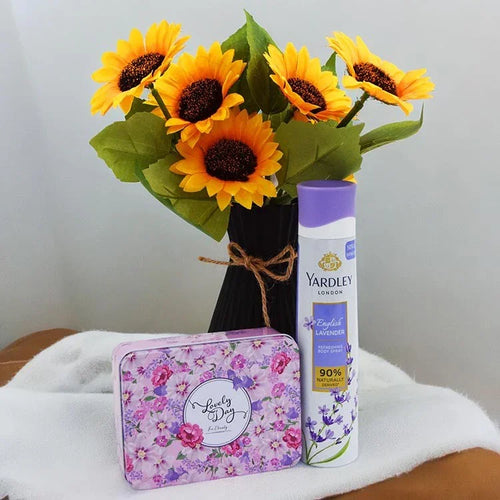 Yardley London product with sunflowers and a floral tin on a white surface