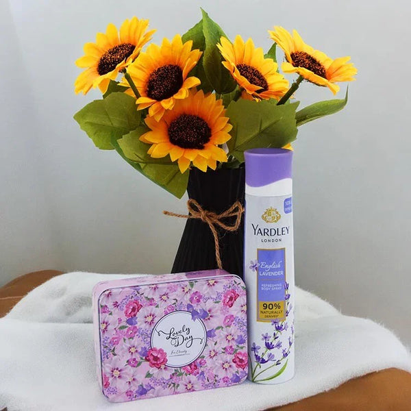 Yardley London product with sunflowers and a floral tin on a white surface