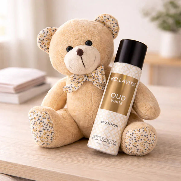 Teddy bear with BellaVita Oud White perfume gift set on wooden table