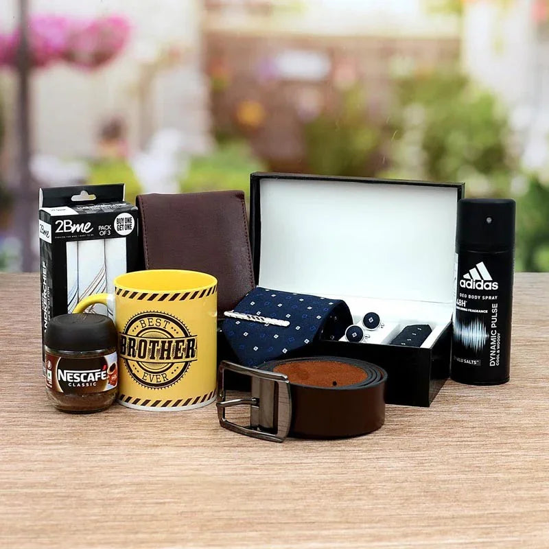 Collection of gifts including a mug, coffee, belt, and other items on a table with a blurred outdoor background.