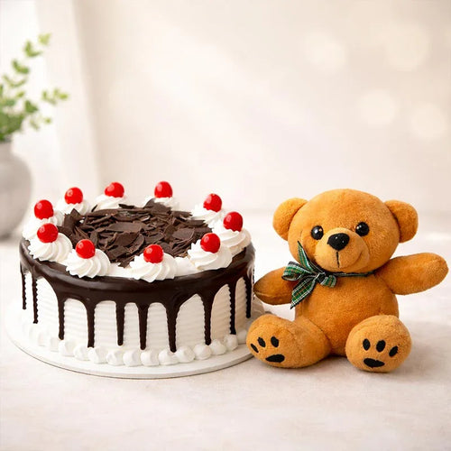 Chocolate cake with red berries and a teddy bear on a light background