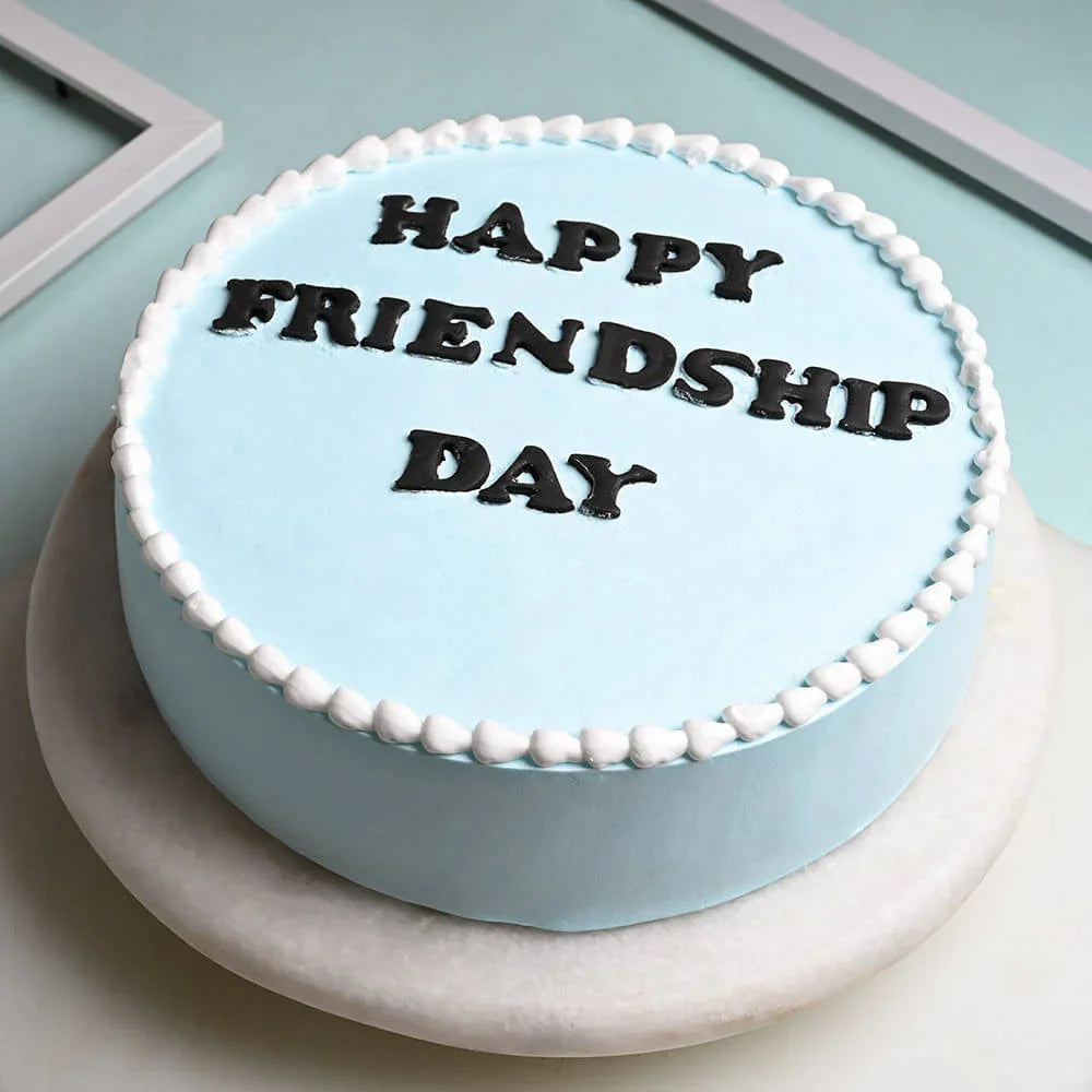Blue cake with 'Happy Friendship Day' text on a light blue background