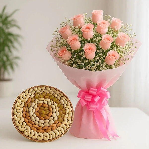 Bouquet of light pink roses with white fillers and a round dry fruits platter on a table