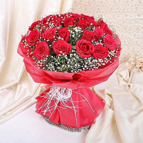 Bouquet of red roses wrapped in red paper 