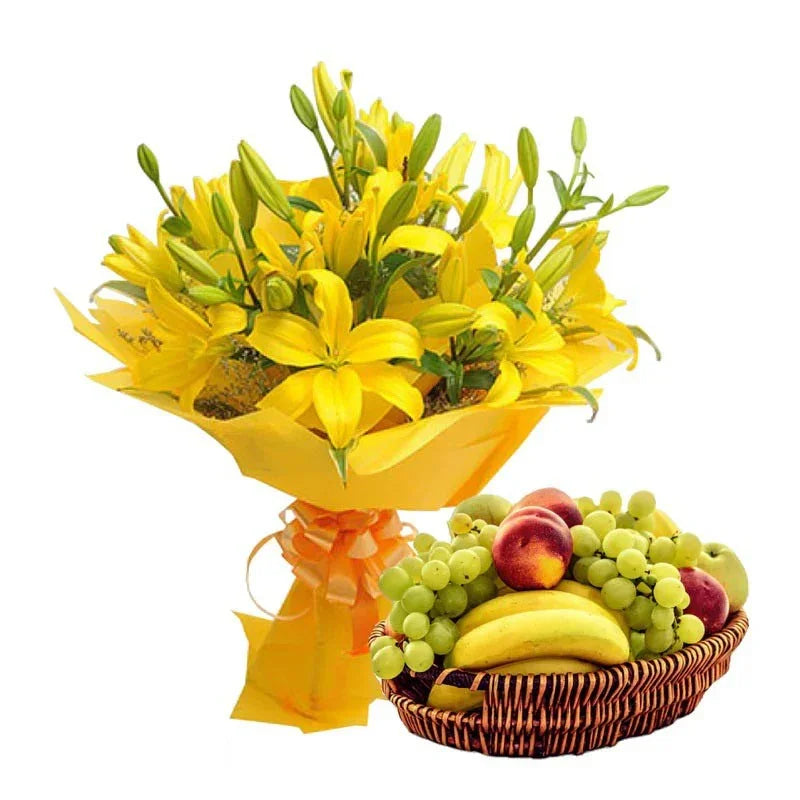 Bouquet of yellow flowers and a basket of fruits on a white background