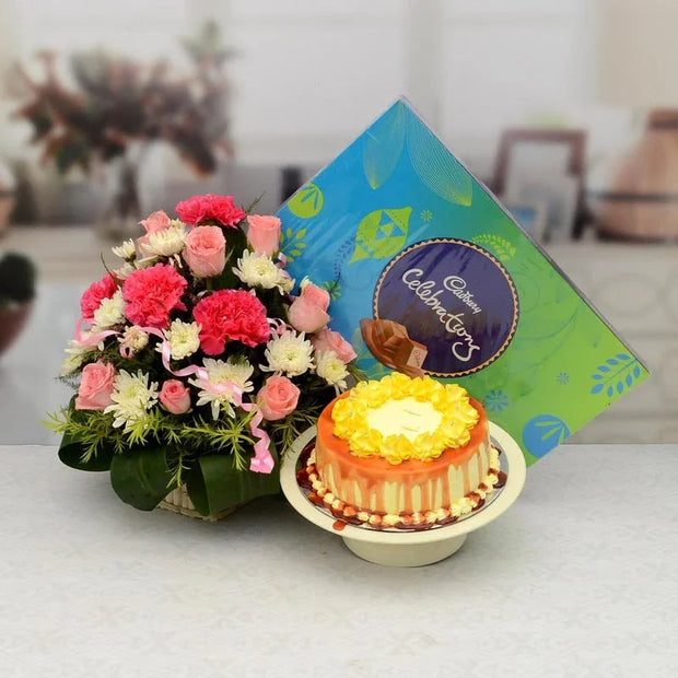 Bouquet of flowers and a small cake with a card on a table.