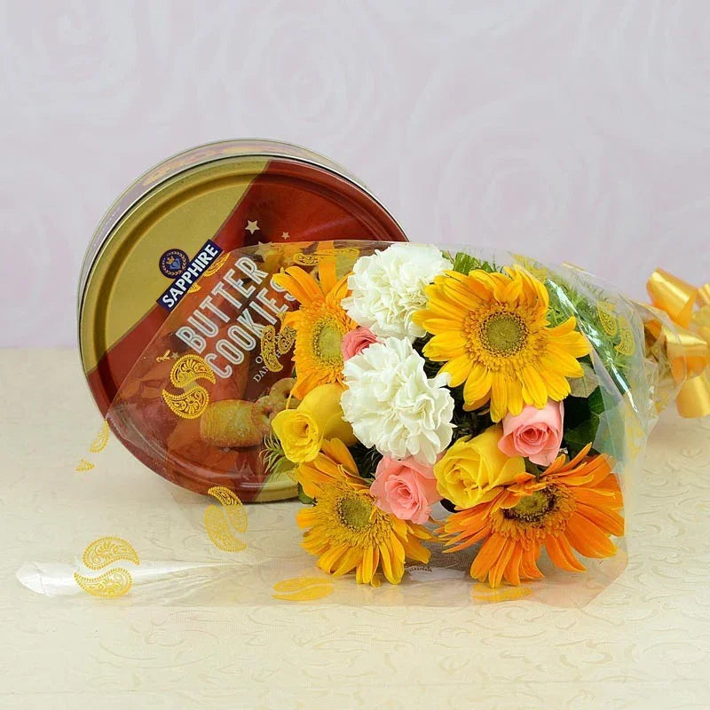 Bouquet of flowers with a container of cookies on a light background