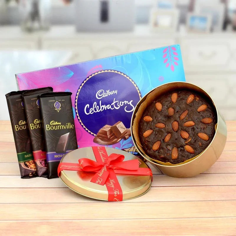 Assorted chocolate items including Cadbury Celebrations, Bournville, and a gold box with cookies on a wooden surface.
