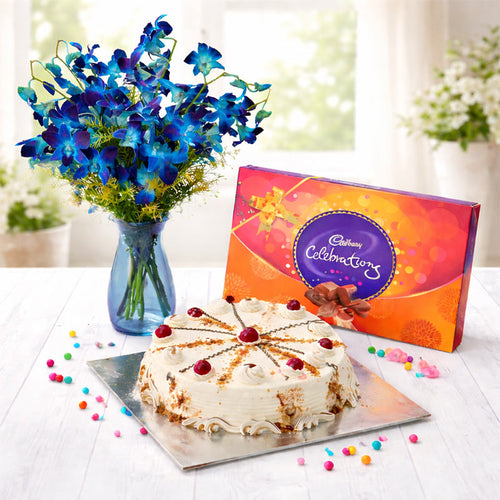 Cake, Cadbury chocolate bar, and blue flowers on a table