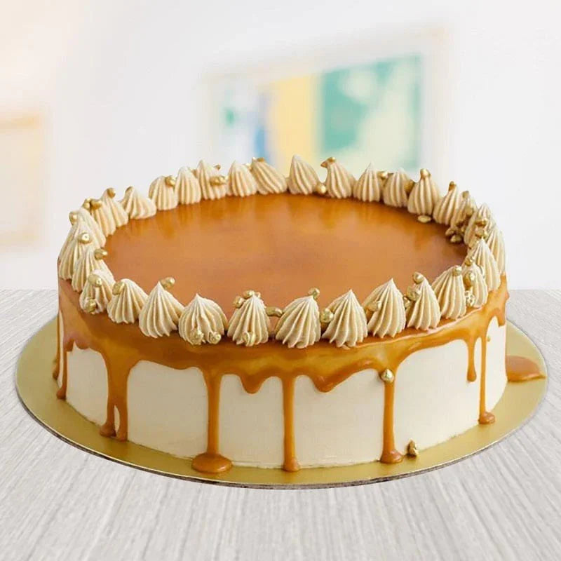 Caramel cake with decorative mounds on a white surface