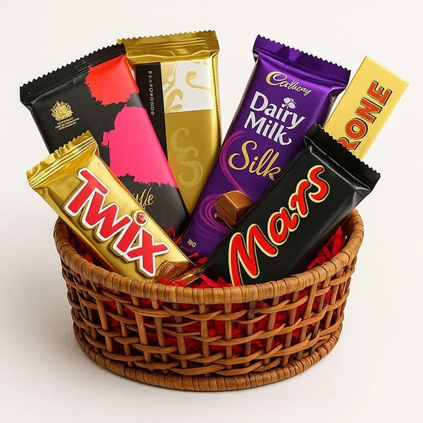 Gift basket with assorted chocolate bars including Dairy Milk Silk, Toblerone, Mars, and Twix.