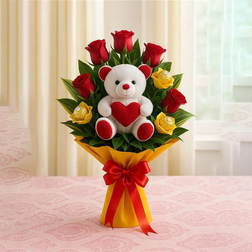 Bouquet of red roses and Chocolates with a white teddy bear featuring a red heart, all wrapped in yellow paper with a red ribbon on a pink surface.