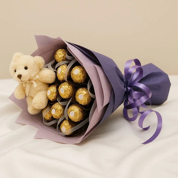 Chocolate bouquet with gold-wrapped chocolates and small teddy bear, purple wrapping