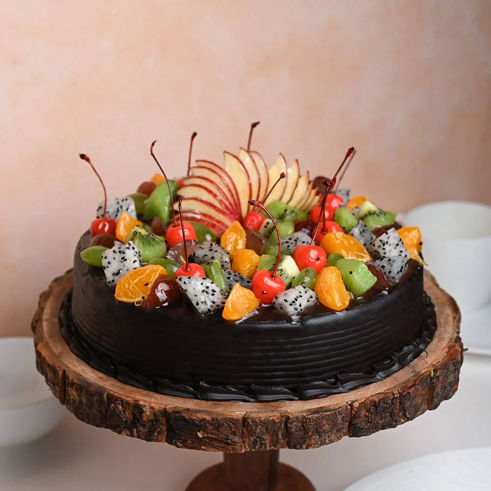 Chocolate cake with fruit toppings on a wooden stand against a neutral background